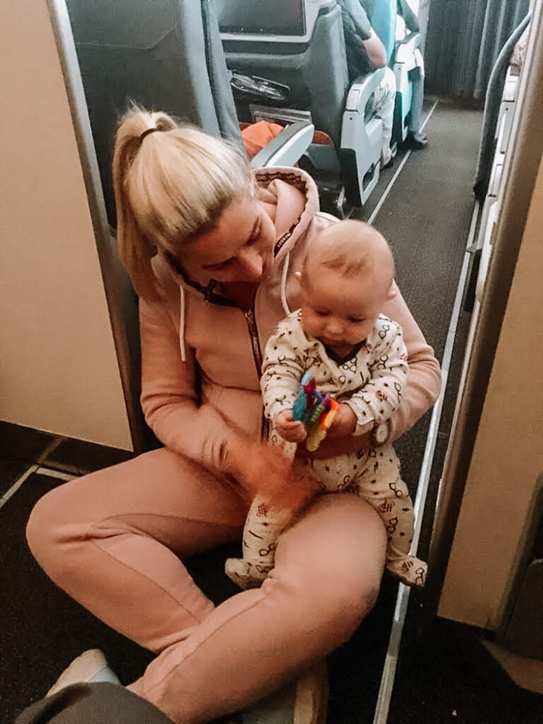 gemma playing with baby george on airplane to singapore